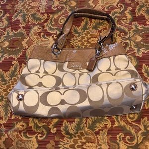 Coach handbag that is tan colored